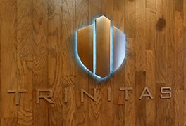 wooden Trinitas logo