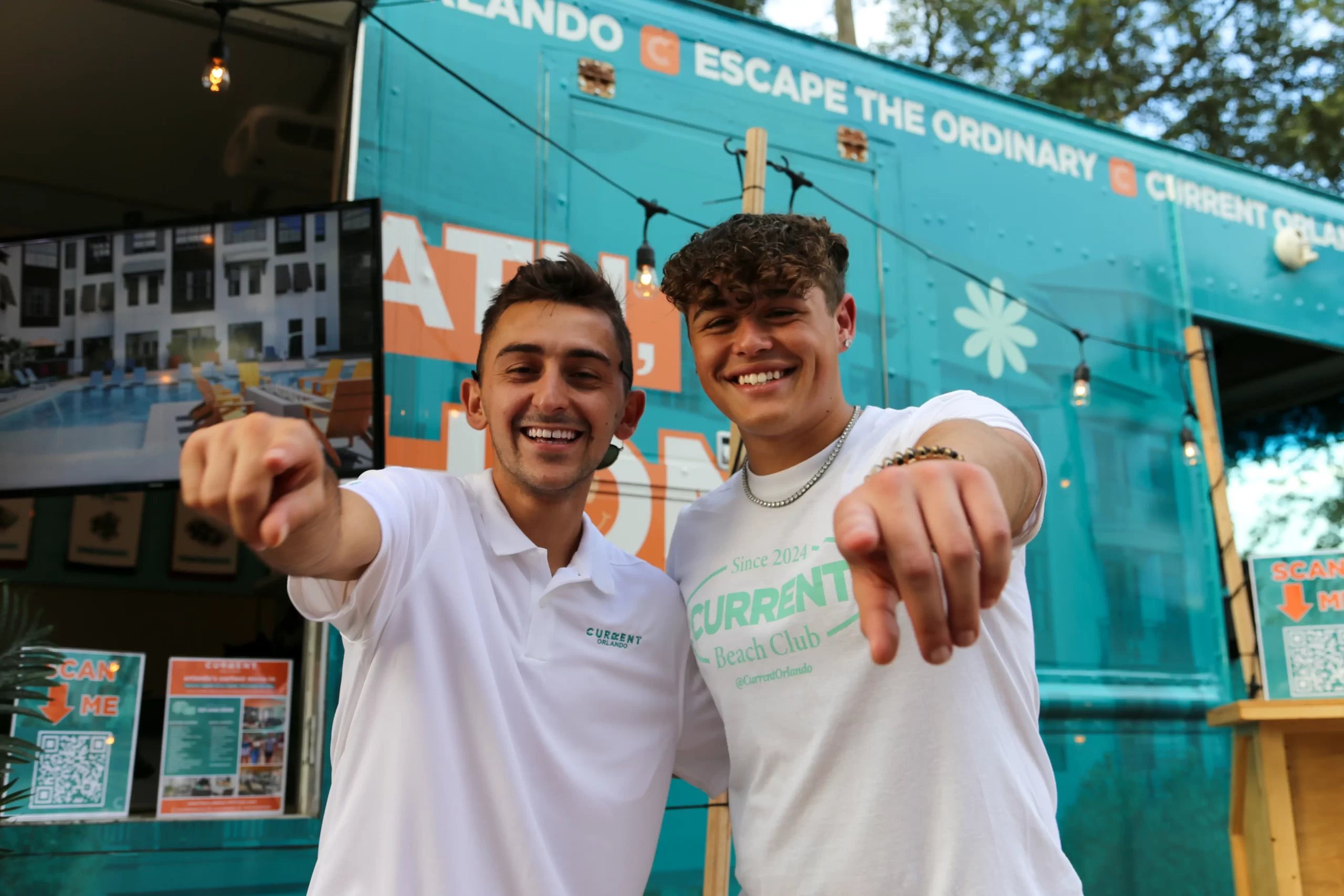 two people pointing at the camera