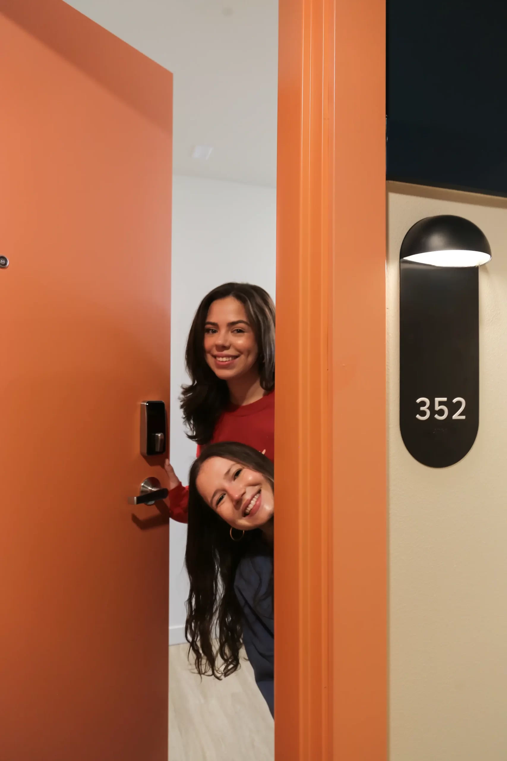 friends peeking out from behind a door